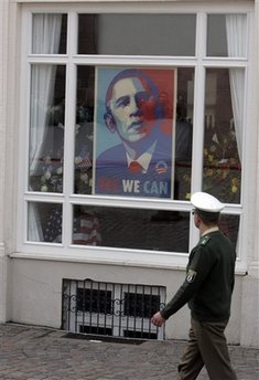 Police officer looks at the Obama poster as he walks in the Baden-Baden market area prior to Obama's arrival on April 3, 2009.