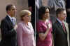 President Barack Obama and German Chancellor Angela Merkel pause for the national anthems of the US and Germany.