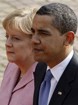 President Barack Obama and German Chancellor Angela Merkel pause for the national anthems of the US and Germany.