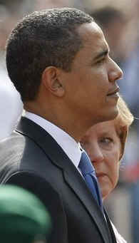 President Barack Obama and German Chancellor Angela Merkel pause for the national anthems of the US and Germany.