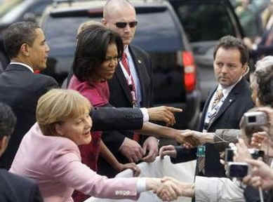 President Barack Obama and First Lady Michelle Obama are cheered by the crowd, and welcomed by German Chancellor Angela Merkel and her husband Joachim Sauer in the market at Baden-Baden, Germany on April 3, 2009.