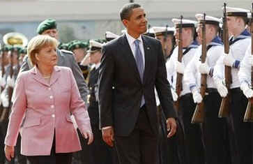 President Barack Obama joins German Chancellor Angela Merkel to inspect a German Military Honour Guard.