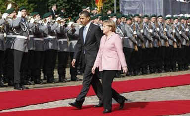 President Barack Obama joins German Chancellor Angela Merkel to inspect a German Military Honour Guard.