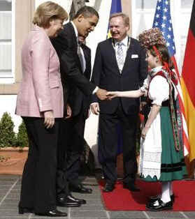 President Obama is greeted by Baden-Baden Mayor Wolfgang Gerstner, and young Germans dressed in traditional Black Forest area dress.