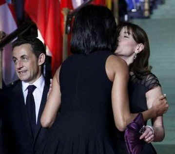 Michelle Obama embraces Carla Buni-Sarkozy at the Kurhaus in Baden-Baden, Germany.