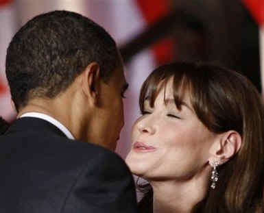 President Barack Obama embraces Carla Bunii-Sarkozy at the Kurhaus in Baden-Baden, Germany.