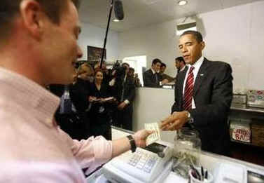 President Barack Obama pays for lunch at Ray's Hell Burger across the Potomac in Arlington, Virginia.