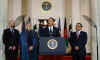 President Barack Obama speaks to the media in the Grand Foyer of the White House after trilateral meetings.