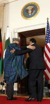 President Barack Obama leaves the Grand Foyer of the White House with Afghanistan's President Hamid Karzai and Pakistan's President Asif Ali Zardari on May 6, 2009.