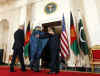 President Barack Obama leaves the Grand Foyer of the White House with Afghanistan's President Hamid Karzai and Pakistan's President Asif Ali Zardari on May 6, 2009.