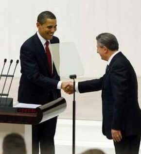 President Obama was led into the Turkish Parliament by Speaker Koksal Toptan. 