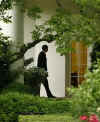 President Obama returns to the Oval Office with aide Reggie Love.