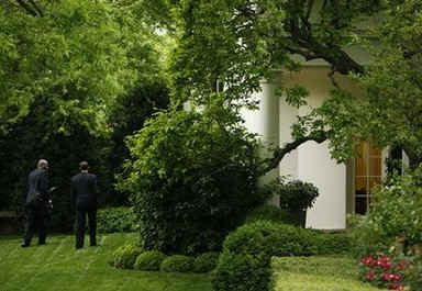 President Obama returns to the Oval Office with aide Reggie Love.
