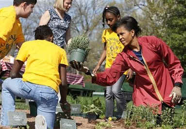 First Lady Michelle Obama Obama tends to her White House Kitchen Garden with help from students of Bancroft Elementary School.