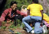 First Lady Michelle Obama tends to her White House Kitchen Garden with help from students of Bancroft Elementary School.