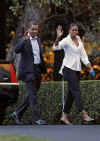 President Barack Obama and First Lady Michelle Obama return to the White House and walk across the South Lawn after a Saturday evening dinner.