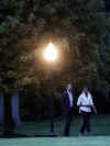 President Barack Obama and First Lady Michelle Obama return to the White House and walk across the South Lawn after a Saturday evening dinner.
