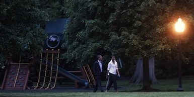 President Barack Obama and First Lady Michelle Obama return to the White House and walk across the South Lawn after a Saturday evening dinner.