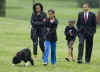 Malia Obama walks with Bo on the South Lawn of the White House on Bo's first day in his new home.