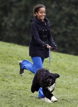 Malia Obama runs with Bo on the South Lawn of the White House on Bo's first day in his new home.