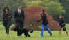 Malia Obama walks with Bo on the South Lawn of the White House on Bo's first day in his new home.