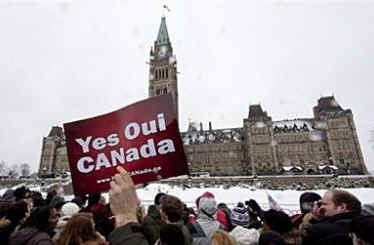 President Obama is greeted by several thousand supporters who braved the cool snowy weather in Ottawa to get a glimpse of the popular President. For security reasons the crowds were well back of the arriving Obama motorcade.