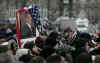 President Obama is greeted by several thousand supporters who braved the cool snowy weather in Ottawa to get a glimpse of the popular President. For security reasons the crowds were well back of the arriving Obama motorcade.