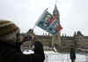 President Obama is greeted by several thousand supporters who braved the cool snowy weather in Ottawa to get a glimpse of the popular President. For security reasons the crowds were well back of the arriving Obama motorcade.