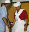 Barack Obama tries on traditional Kenyan clothing while on a visit to Kenya in 2006.