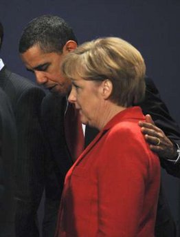President Obama escorted German chancellor Angela Merkel from the stage after making gestures during the first G20 group photo.
