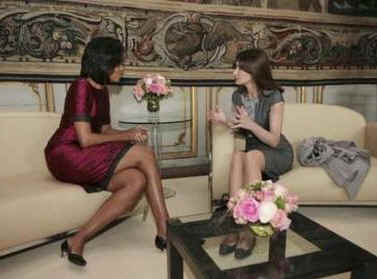 Michelle Obama and Carla Bruni-Sarkozy get to know each other in a private palace meeting room.